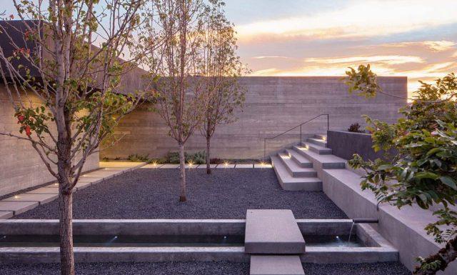 一層現(xiàn)代風格山間別墅，兩面混凝土墻壁打開整個建筑空間